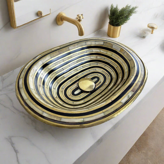 Top view of handcrafted brass sink with resin and bone inlay, showcasing intricate Moroccan design and polished brass finish